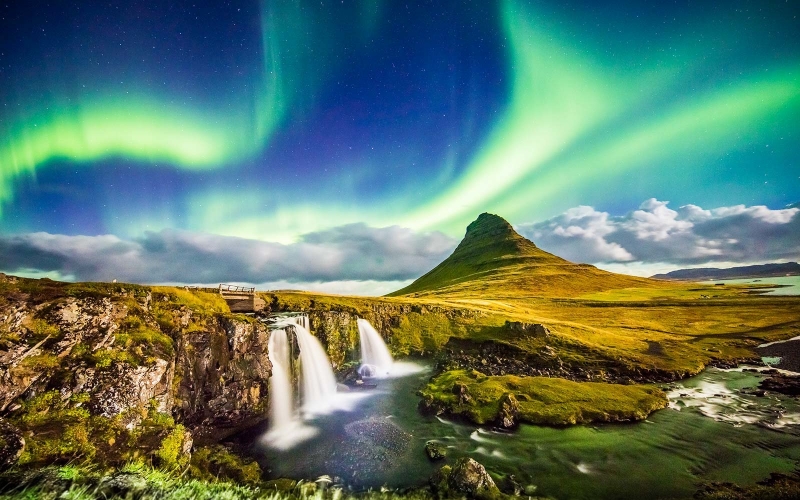 Aurora over Kirkjufell and waterfall at night