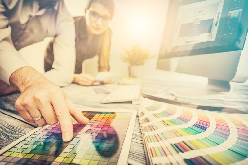 Graphic designer at work. Color samples.