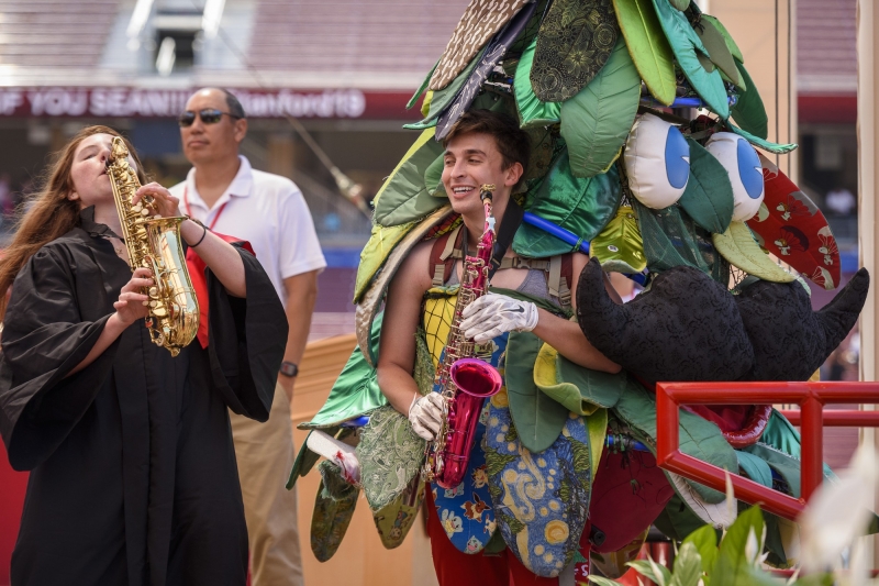 The Tree mascot doubles on alto saxophone during a song with the Stanford Band.