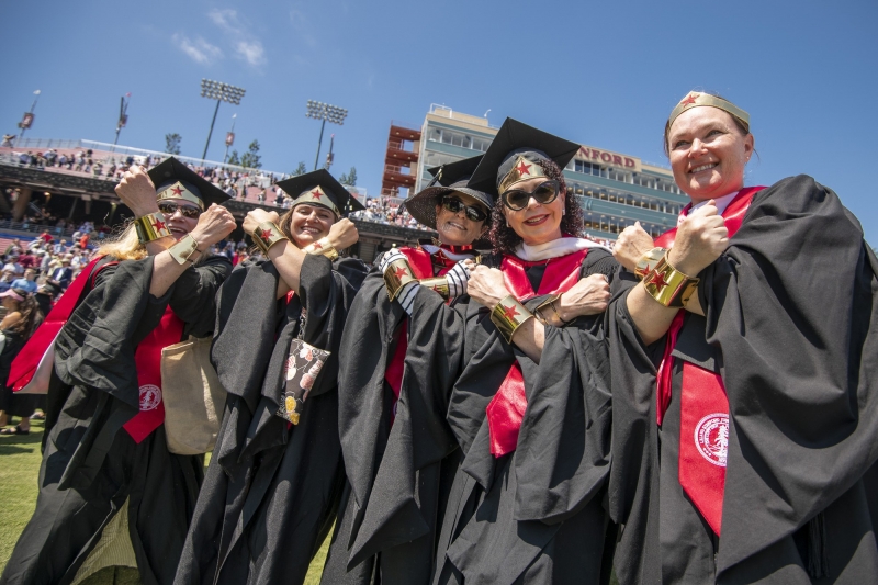 Graduates receiving thier MLA degrees declare themselves Wonder Women.