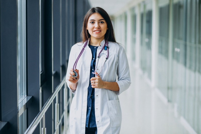 Young woman doctor with stethoscope at hospital