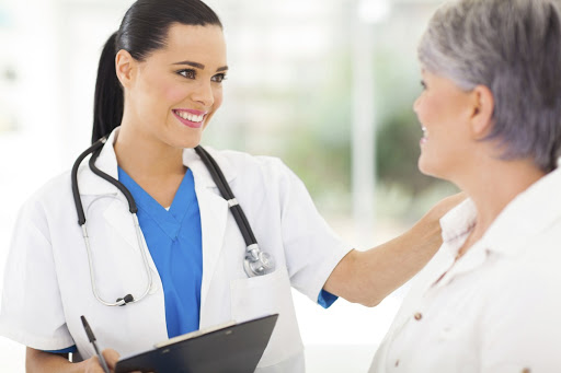 female doctor comforting middle aged patient